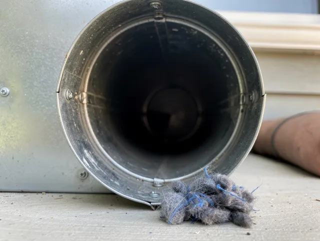 North Branford Dryer Vent Cleaning technician using specialized equipment to clear severe dryer vent blockage in North Branford